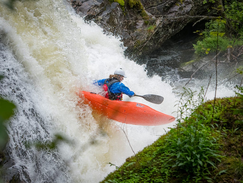 Man in kyack going down a water fall