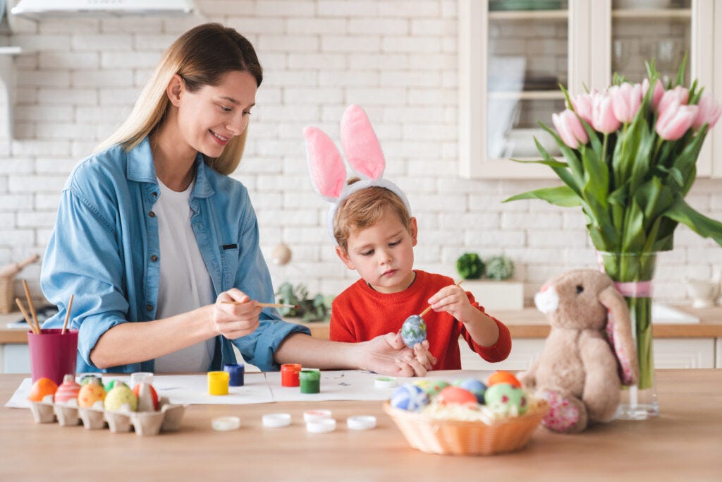 Mom and son decorating Easter Eggs — shows the Egg Decorating tradition at Easter