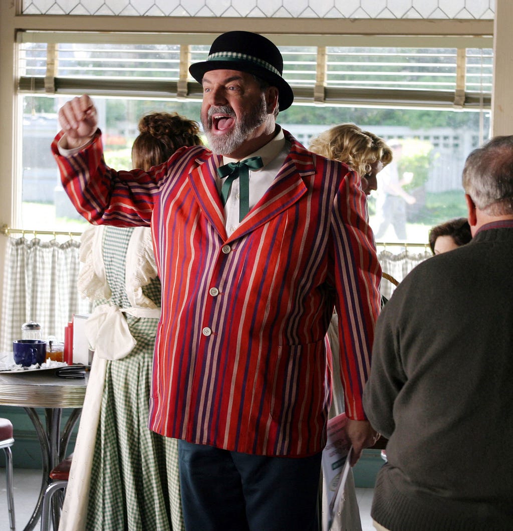 Photo of Mayor from Gilmore Girls dressed up in a scenic type of getup that you know people would just love to have riddled with bullets.