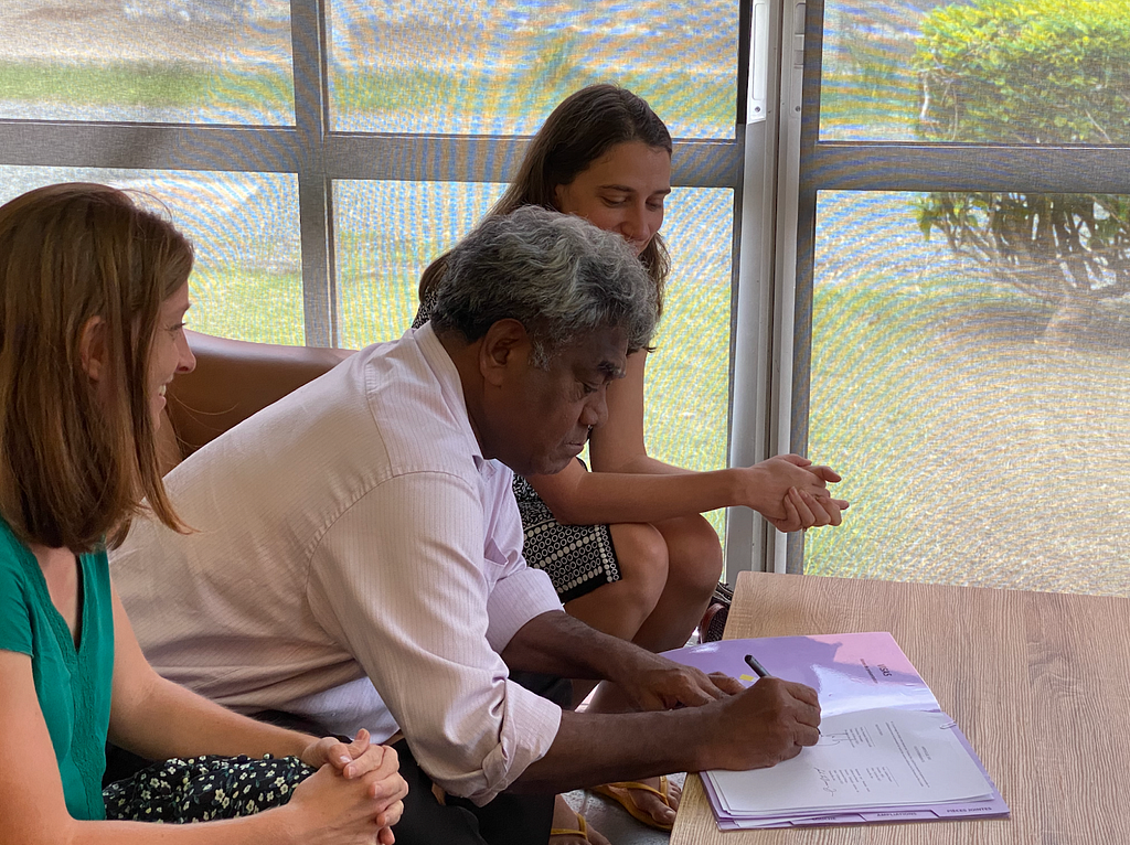 Stéphanie Fabre, a rheumatologist leading the study in New Caledonia, and Sarah LeBaron von Baeyer from Variant Bio signing a Memorandum of Understanding with Jacques Zanehno Lalié, President of the Loyalty Islands.