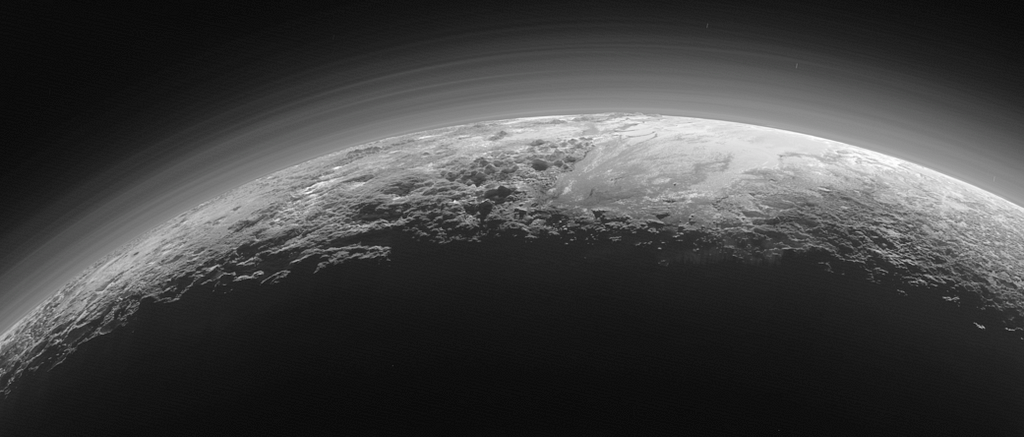 An edge-on image of Pluto’s water ice mountains and the haze layers of atmosphere.