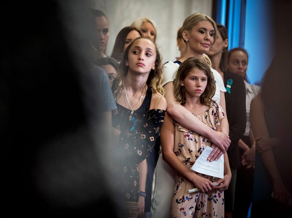 Sarah Klein embraces Mimi Wegener alongside fellow survivors of sexual abuse by Larry Nassar during a 2018 press conference in Washington D.C. to discuss ways to prevent further abuse.