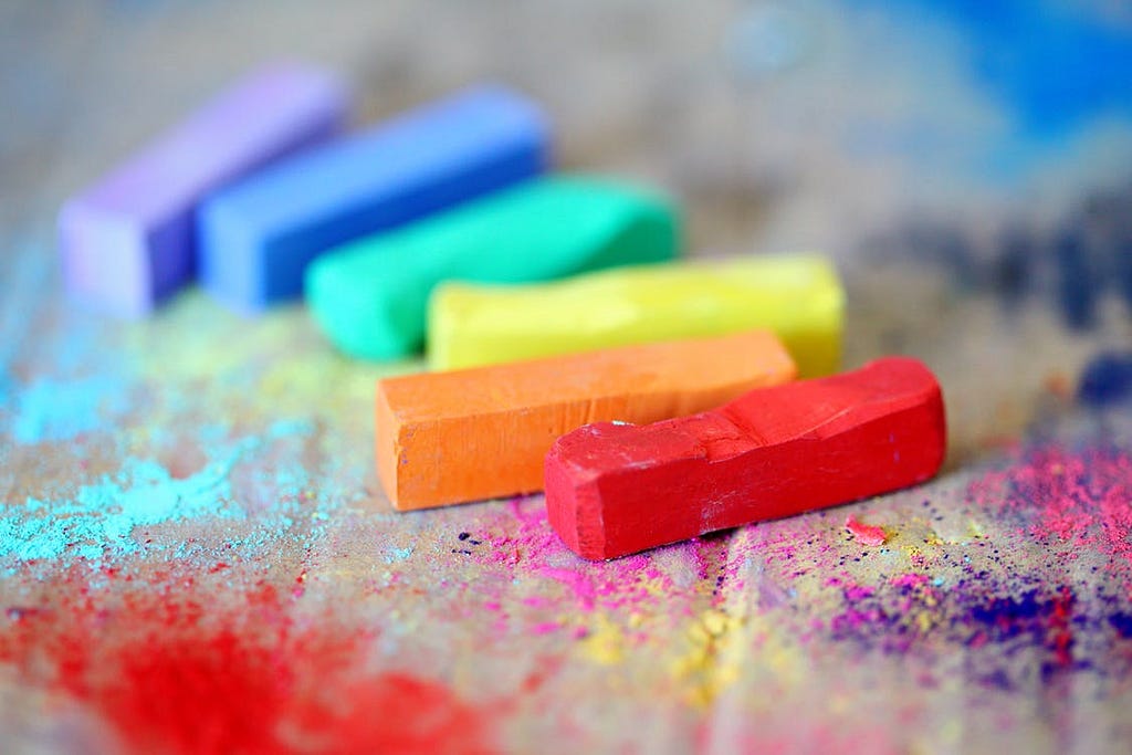 A row of chalk sticks forming a rainbow