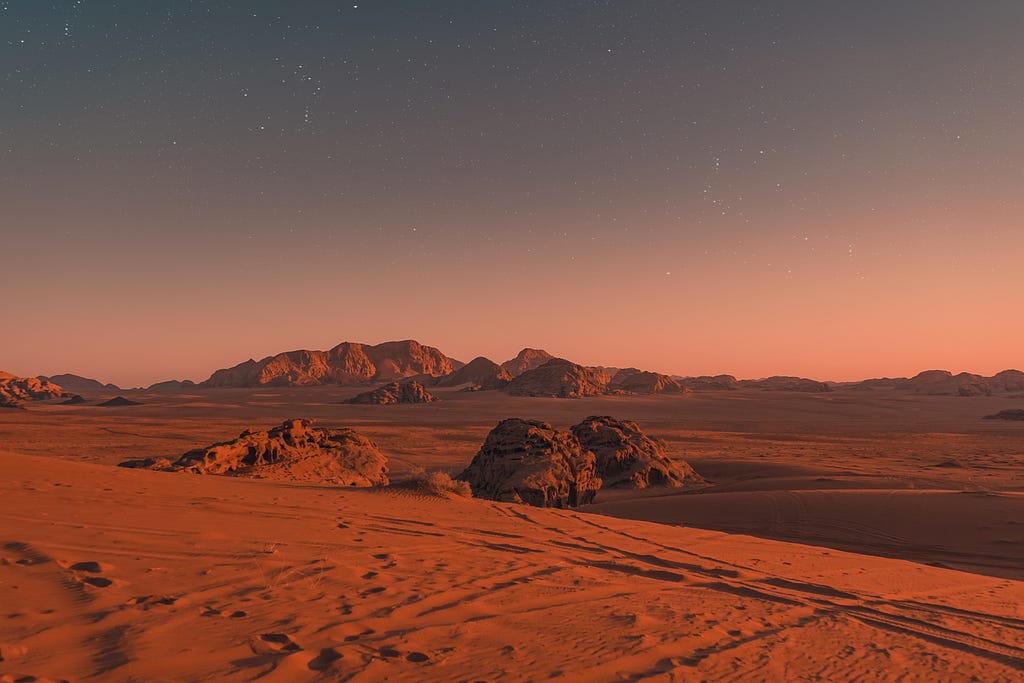 Red/orange sand with large rocks. A Martian landscape.