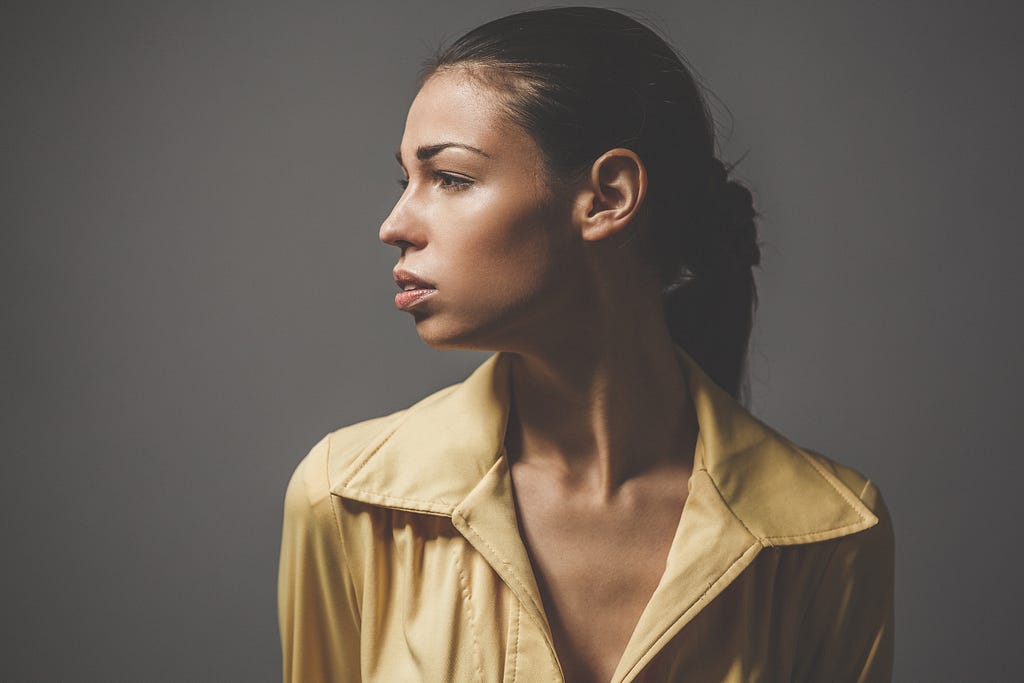 Photo by Samuel Dixon from unsplash of a beautiful woman listening.