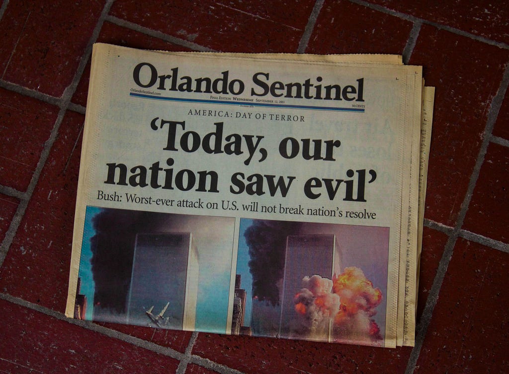 Newspaper showing news of the 9/11 attacks. (Aidan Bartos on Unsplash)