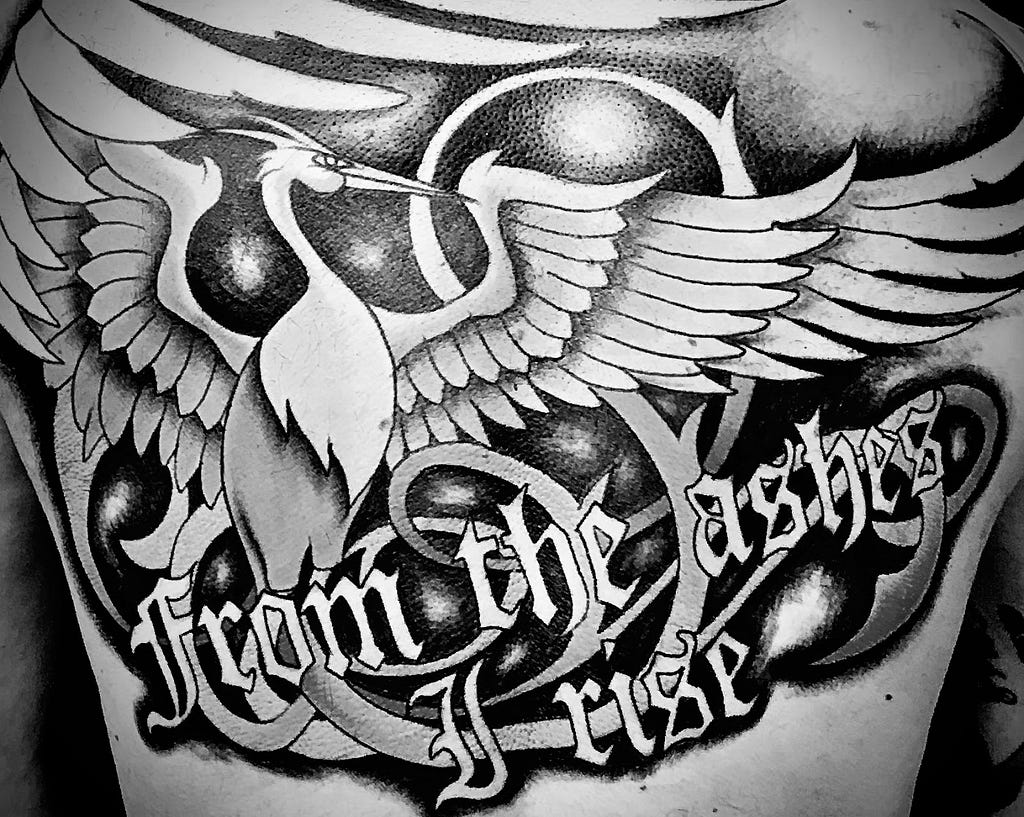 Pheonix tattoo on my back with the words “From the ashes I rise” — Photo by Paul Fjelrad