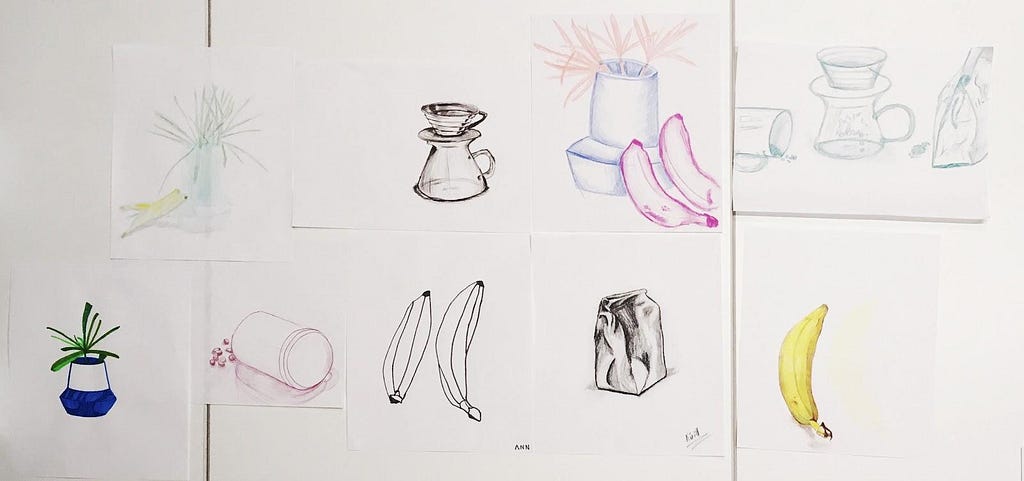 Selection of still-life sketches taped next to each other on an office whiteboard