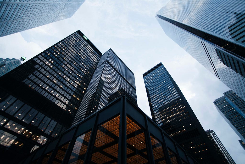 This is a photo of buildings. The picture was taken looking up into the sky.