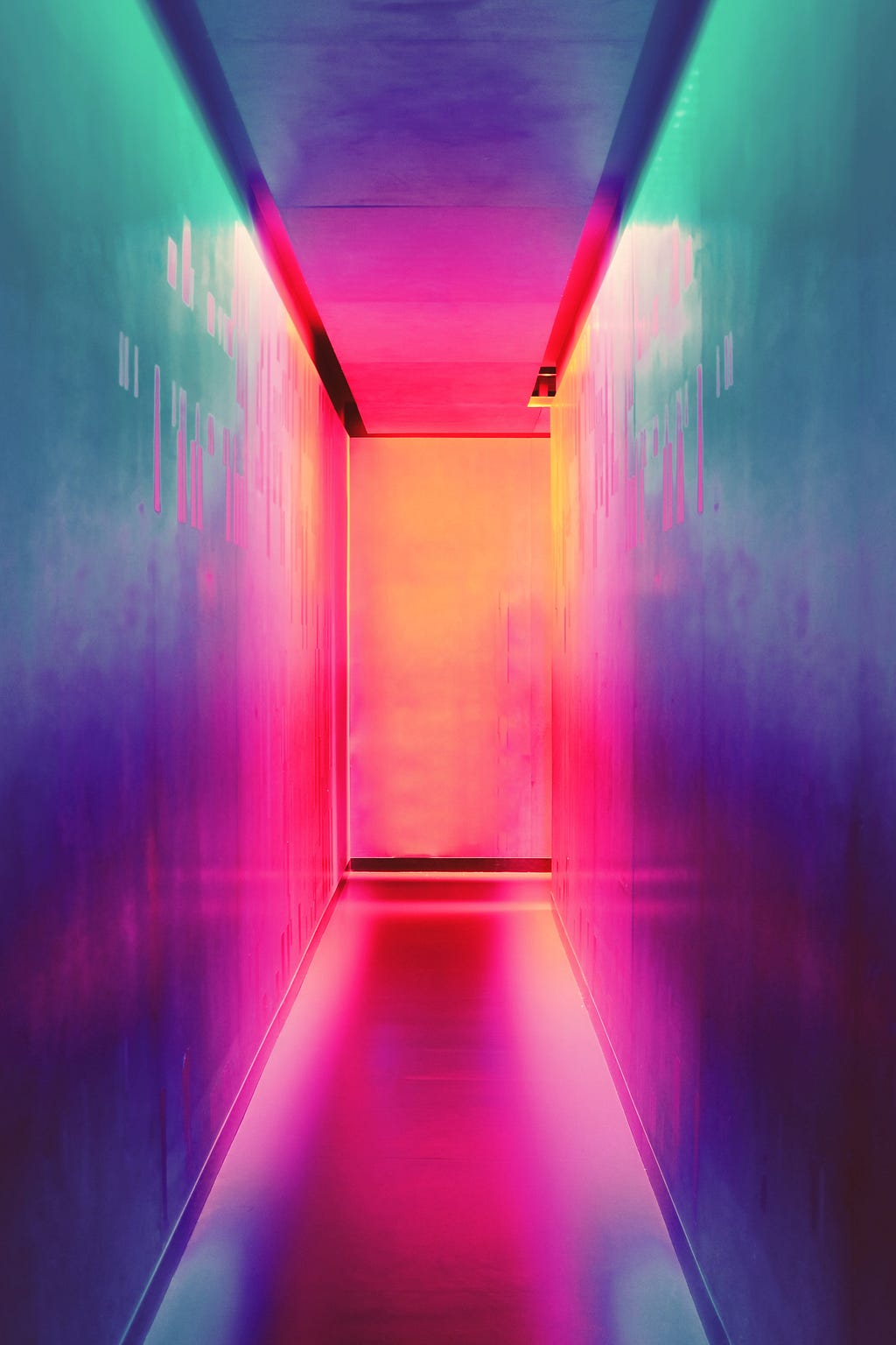 A colourful pathway leading towards a door and/or end of a hallway.