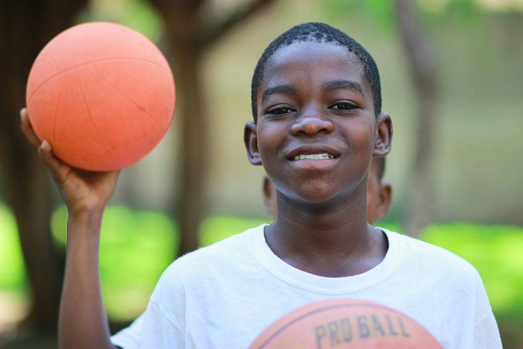 child holding a basketball
