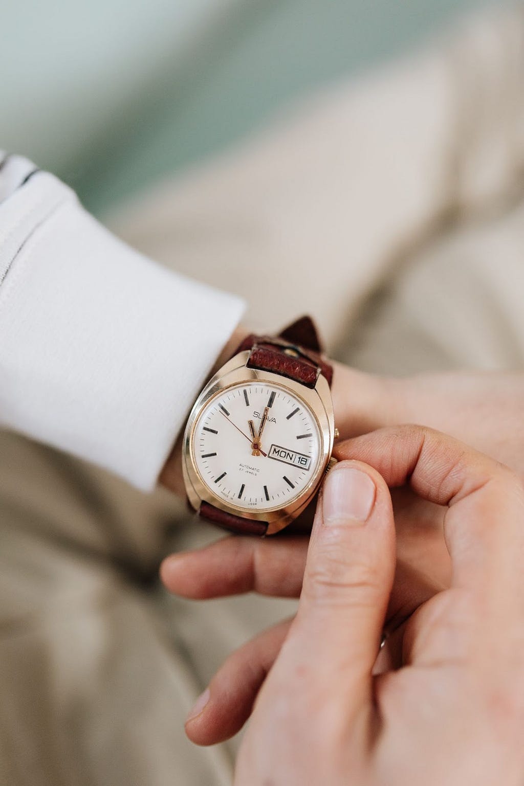 A person setting up his wrist watch.