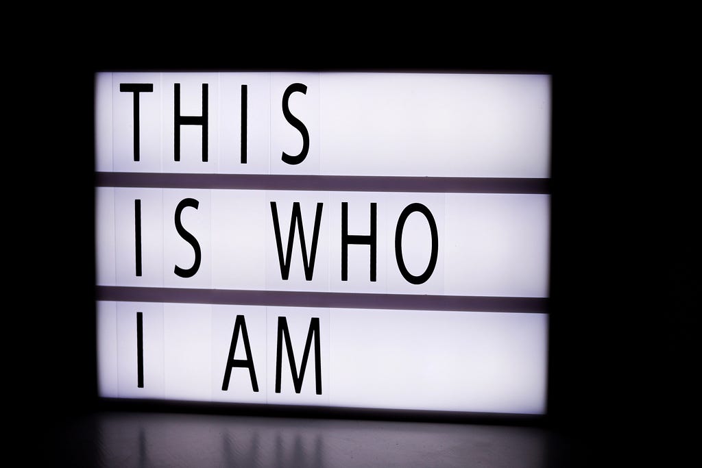 Lit sign that says “this is who I am”