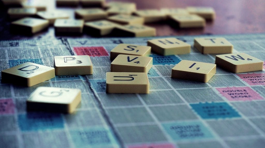 Scrabble letter tiles lying on the boardgame