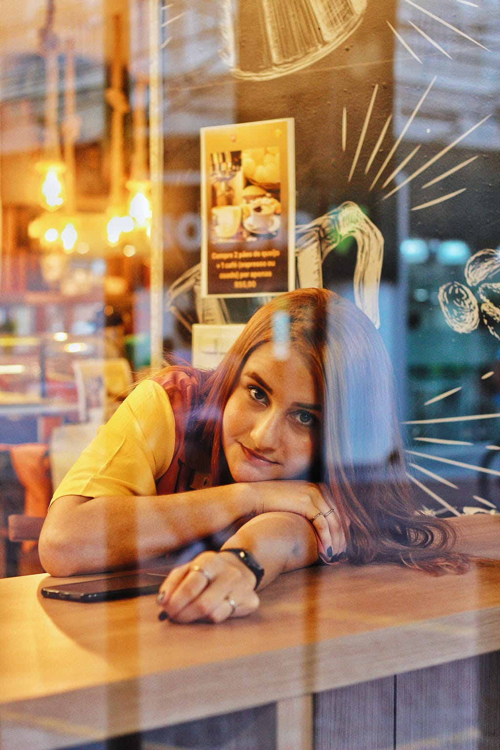 A girl behind a glass