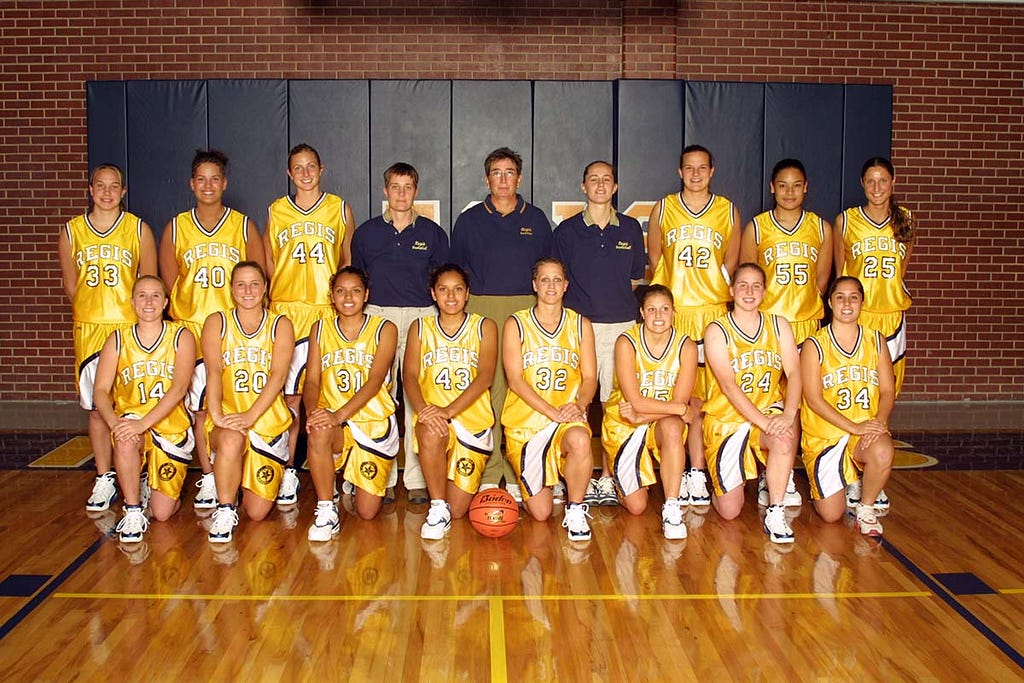 The Regis Rangers basketball team poses for a team photo in the Fieldhouse on the Northwest Denver campus