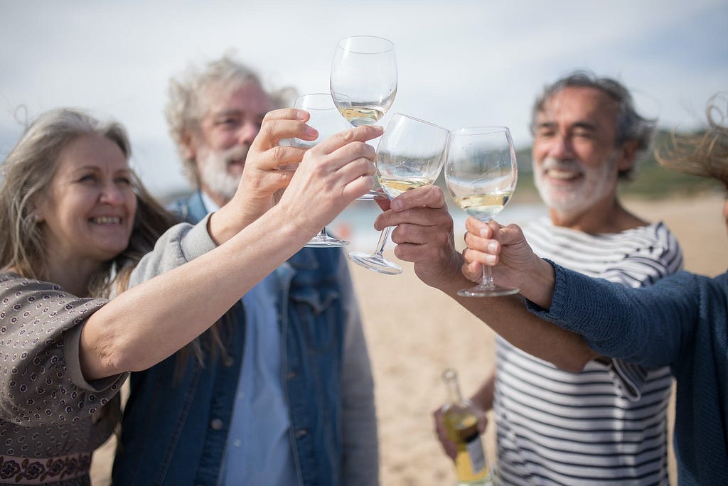 seniors having a toast in the beach