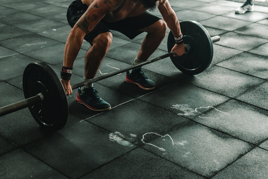 Man lifting heavy weight in a gym