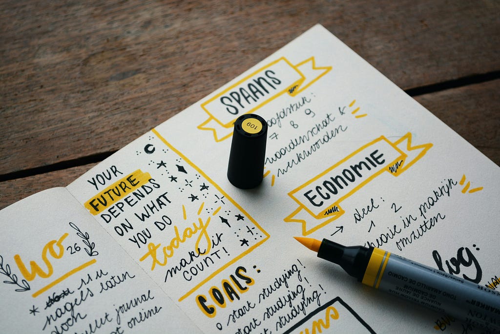 A colourful notebook with goals written in, for a website about launching a wesbite in 20206