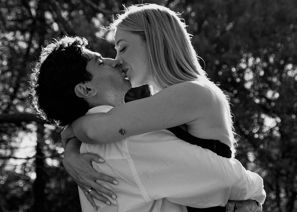 A couple kissing and embracing each other