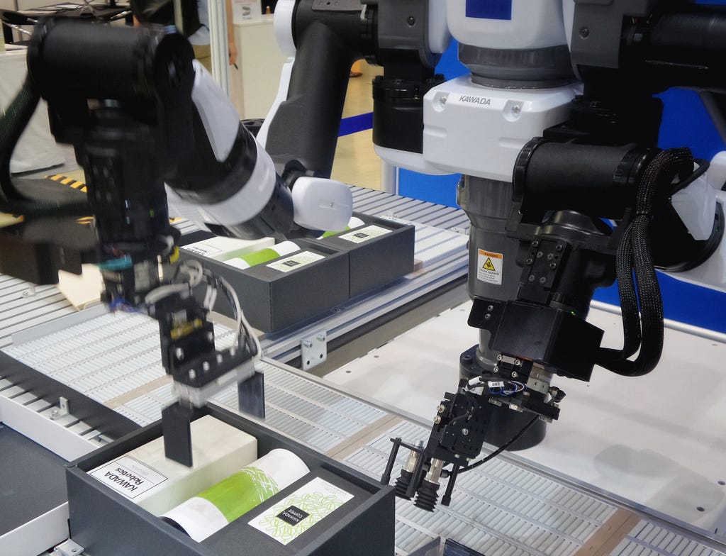 An automated robot placing products in a box.