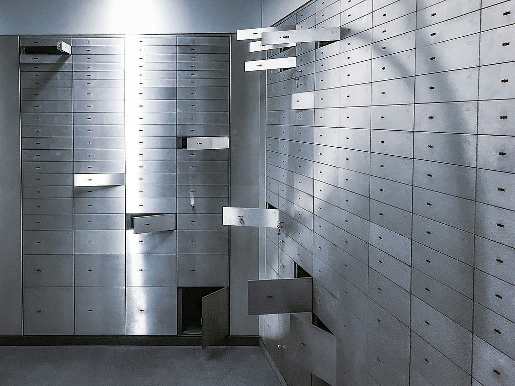 A lock-box room filled with rows of lock-boxes, a few standing open
