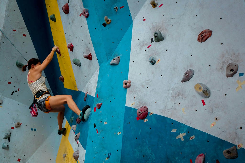 a woman bouldering