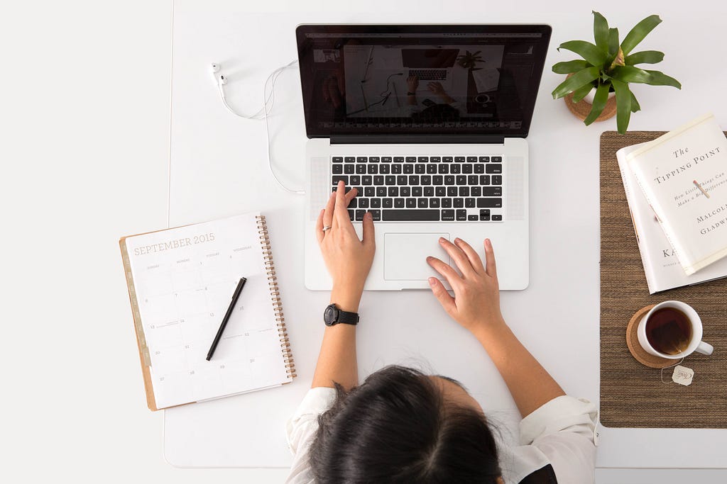 Woman studying at home on her laptop