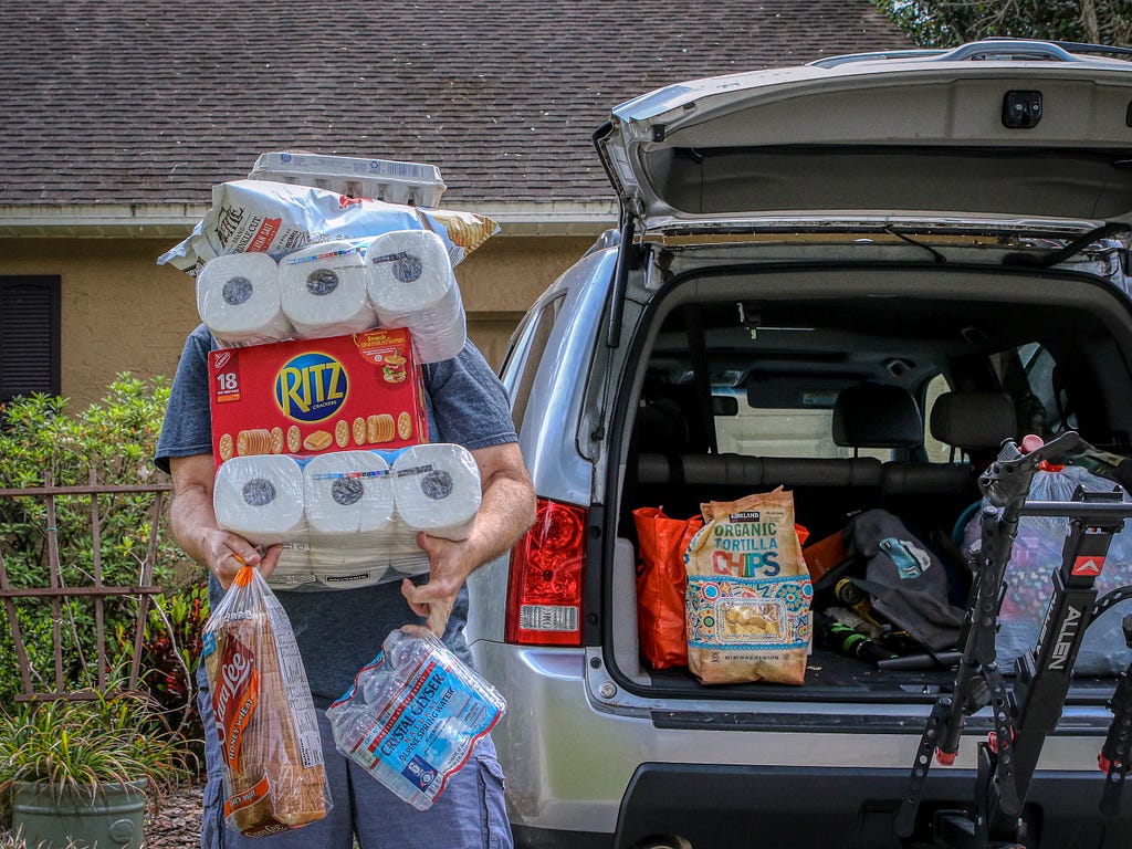 Person bringing supplies to their trunk