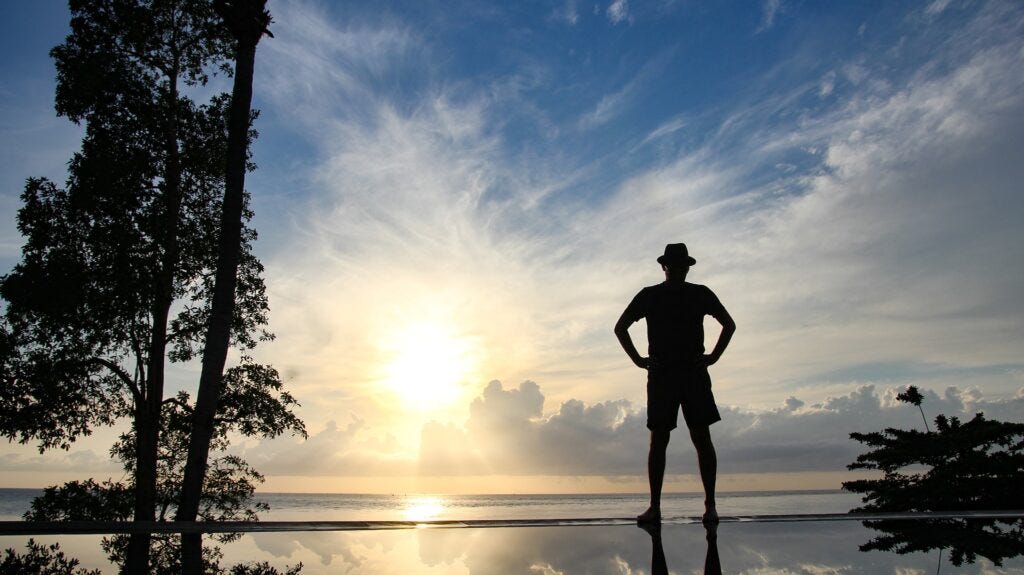 Man silhouette watching sunrise