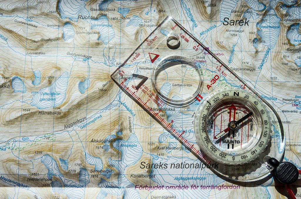 A map of a national park in Sweden, with an orienteering compass on top.