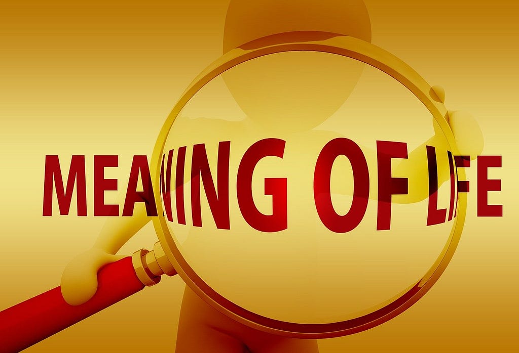 A hand magnifying glass over the sentence that says “Meanikng of Life”