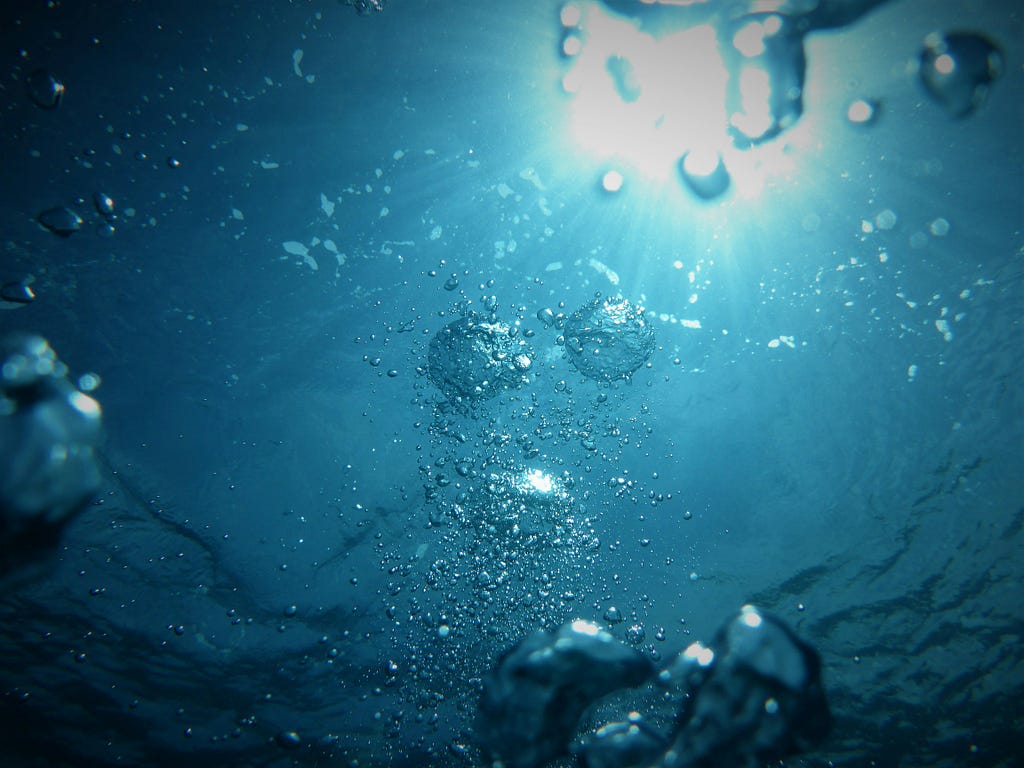 Image of water just below a disturbed surface with bubbles