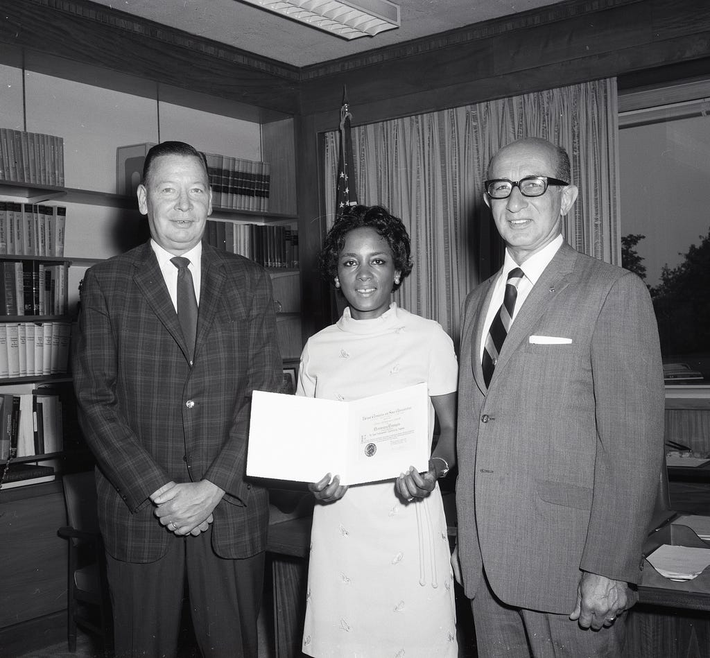 Photo of Henry Barnett (left) and Gene Manganiello (right) gave Annie Easley the special achievement award. 1970