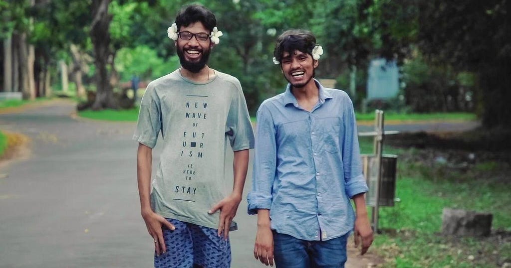 Two people walking through the campus, with one’s shirt ironically reading “New wave of futurism is here to stay”