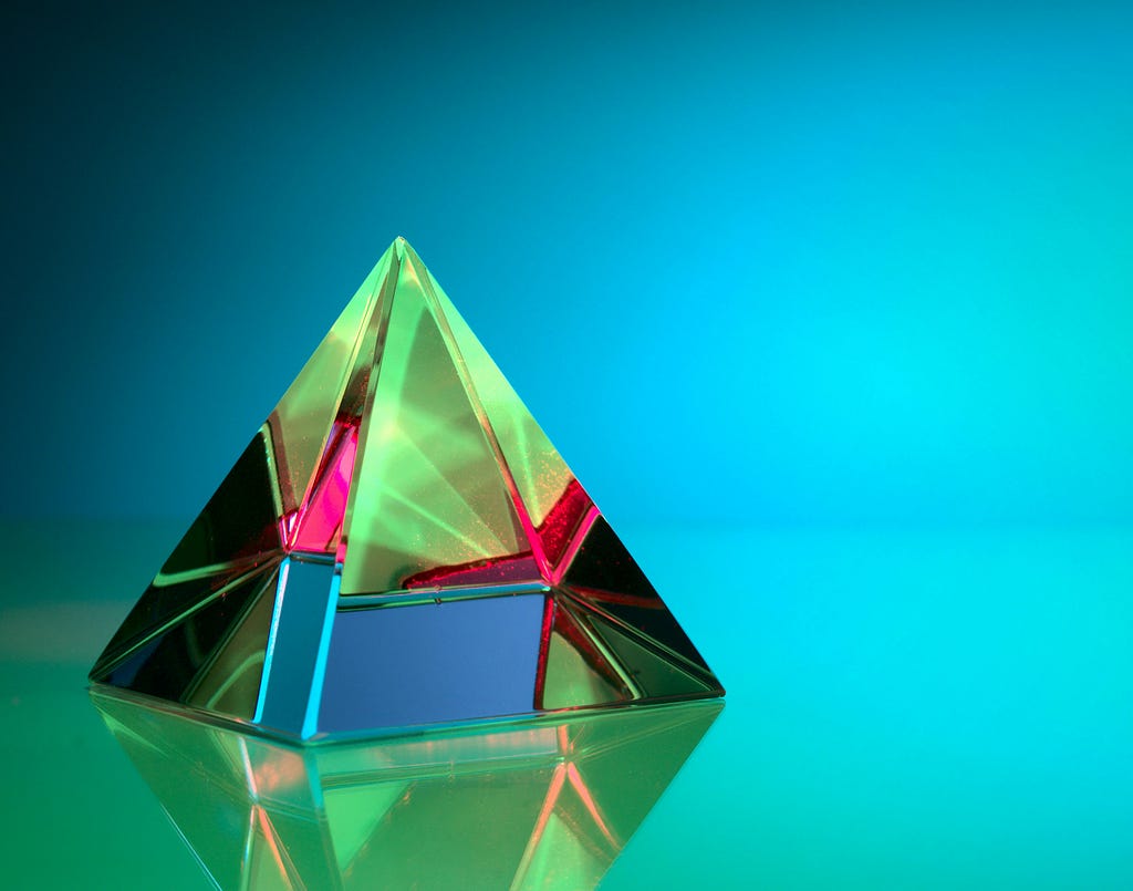 A prism filled with rainbow colors on a blue background