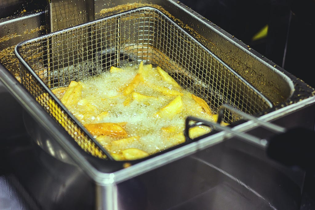 Image of Deep frying of some snacks in a grilled holder