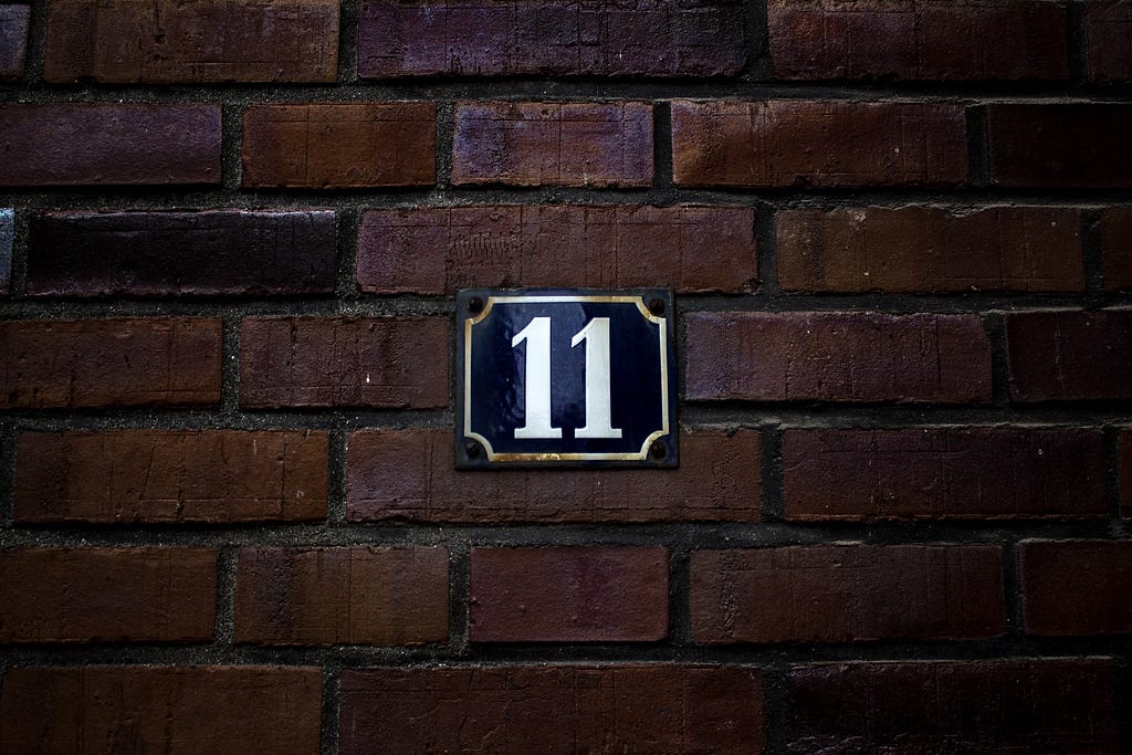 Brick wall displaying 11 as a house number