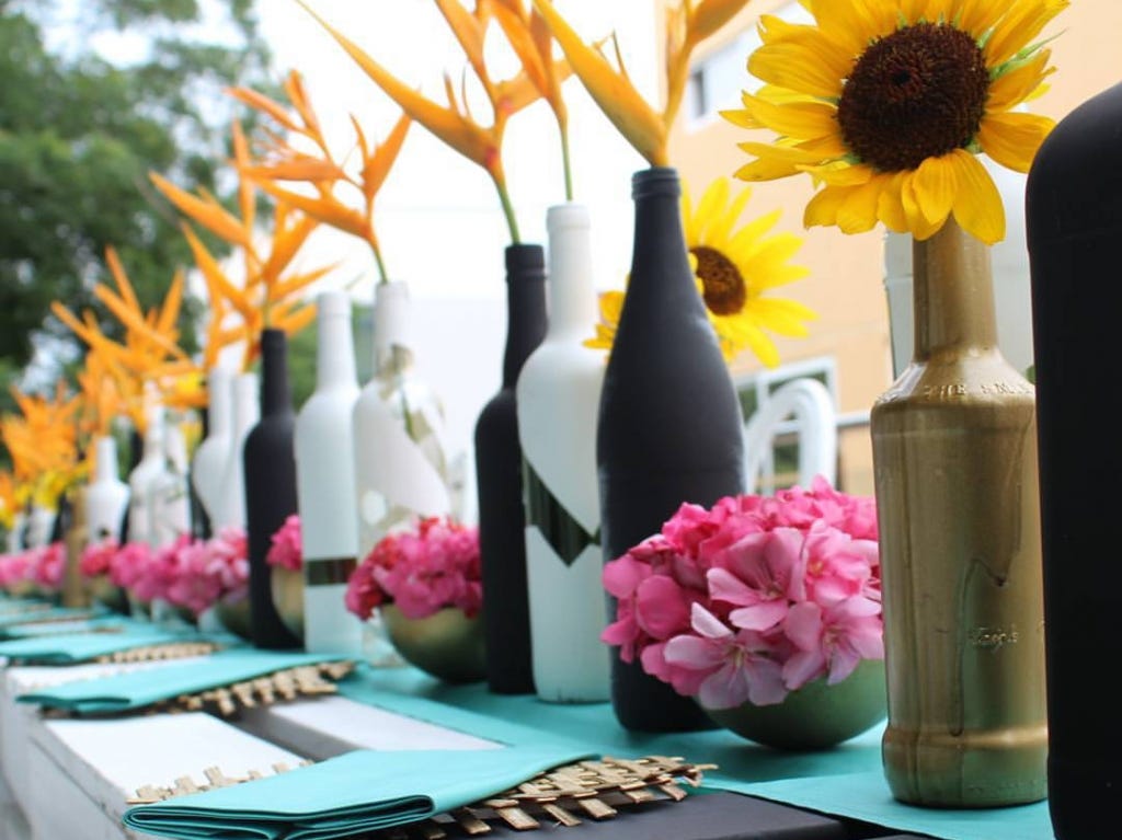 Wine and beer bottles reclaimed as vases.