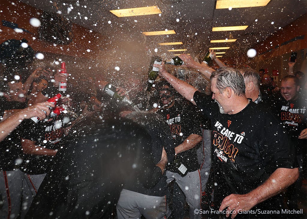 Conor Gillaspie receives a champagne shower as he enters the clubhouse.