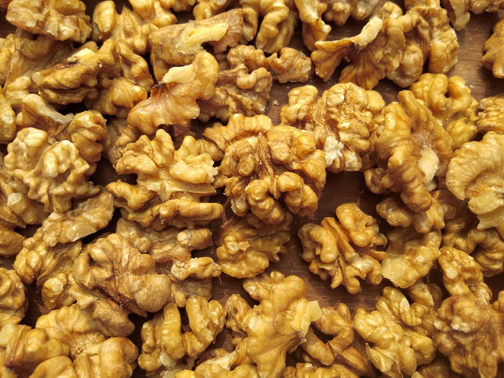 Walnuts in a pile on a table