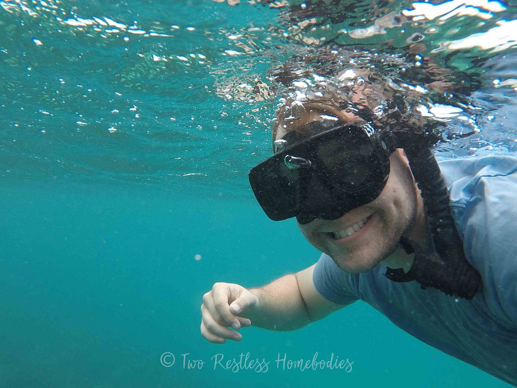 Luke snorkeling Silk Caye reef in Belize