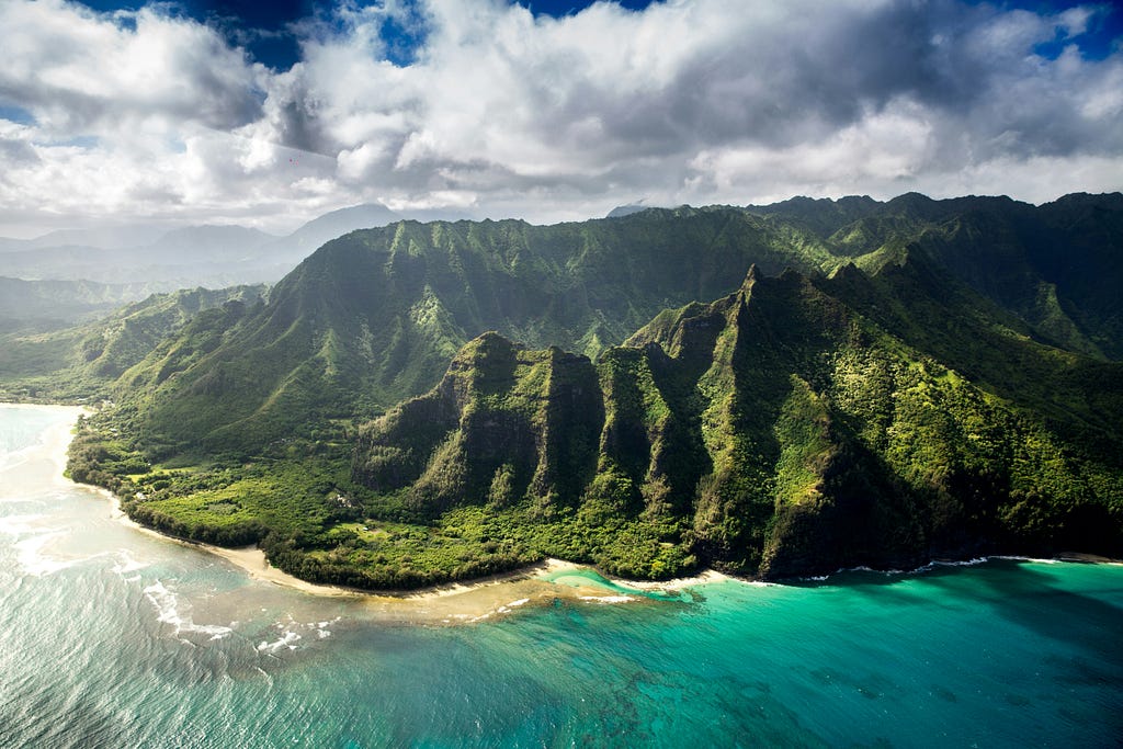 Virtually travel to the stunning scenery of Hawaii. Extremely green coastline with vivid blue waters and white sand beaches.