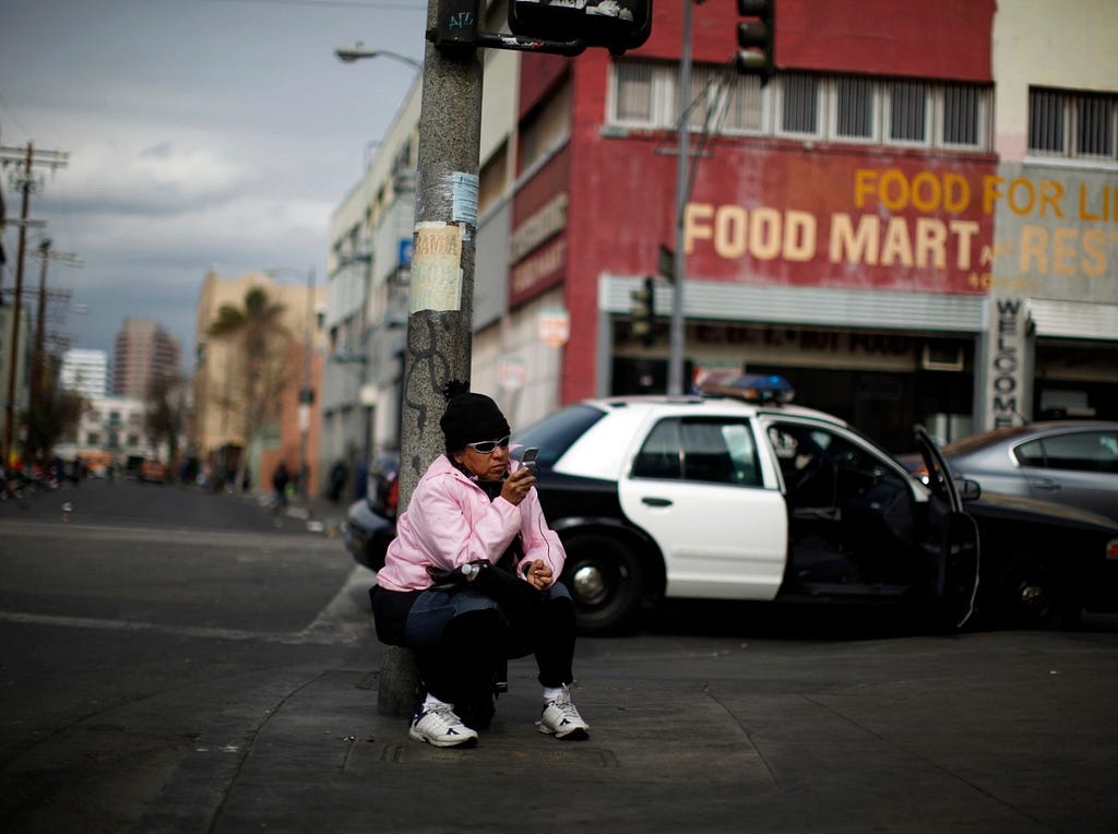 A woman uses a cell phone on downtown Los Angeles’ Skid Row, March 6, 2013. Photo by Lucy Nicholson/Reuters