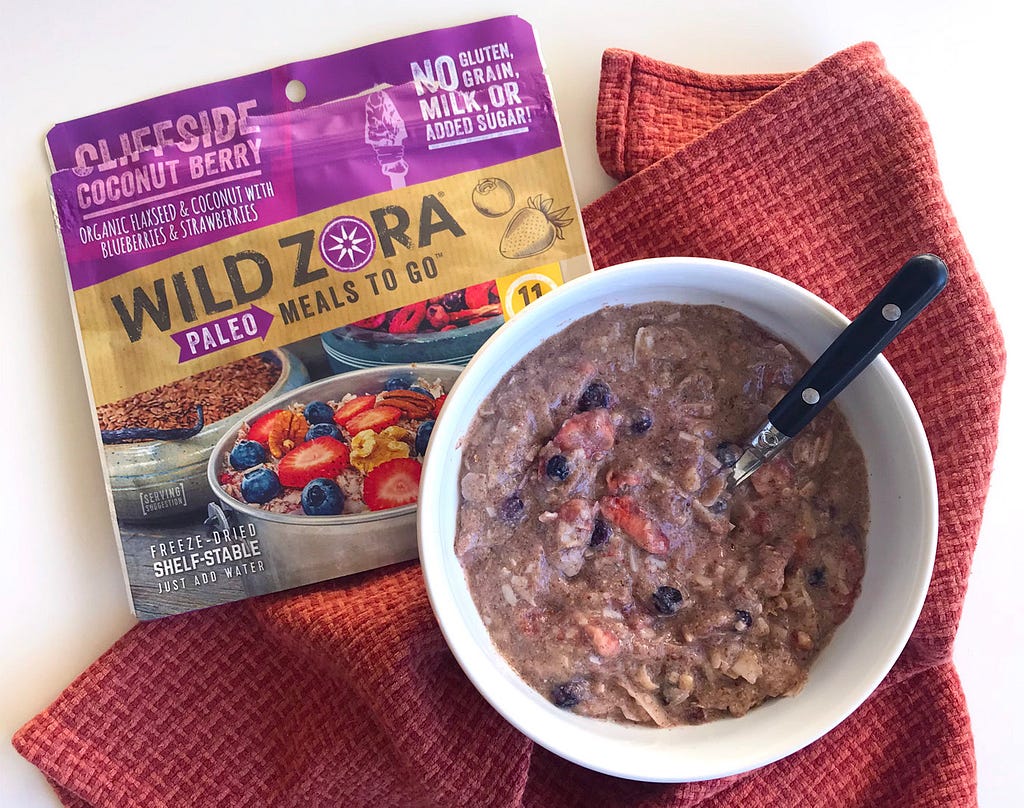 wild zora paleo meals to go cliffside coconut berry package next to a white bowl