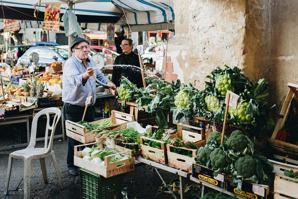 Vegetable Seller in a Market in Italy