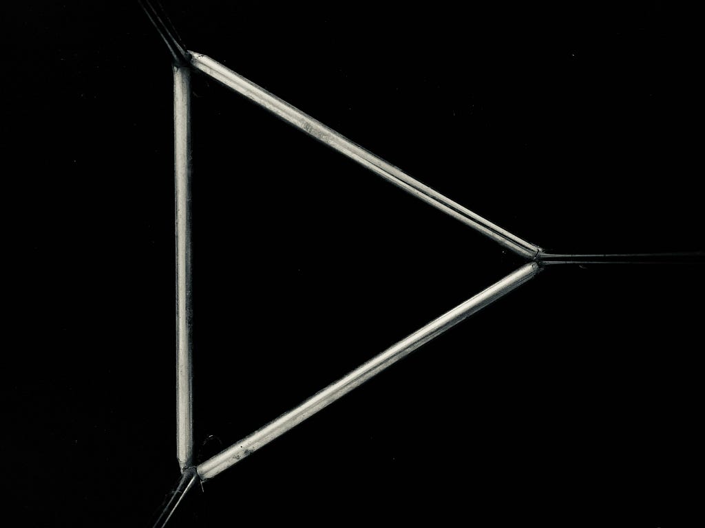 Triangular base of a metal plant stand forms a play button! 🎶