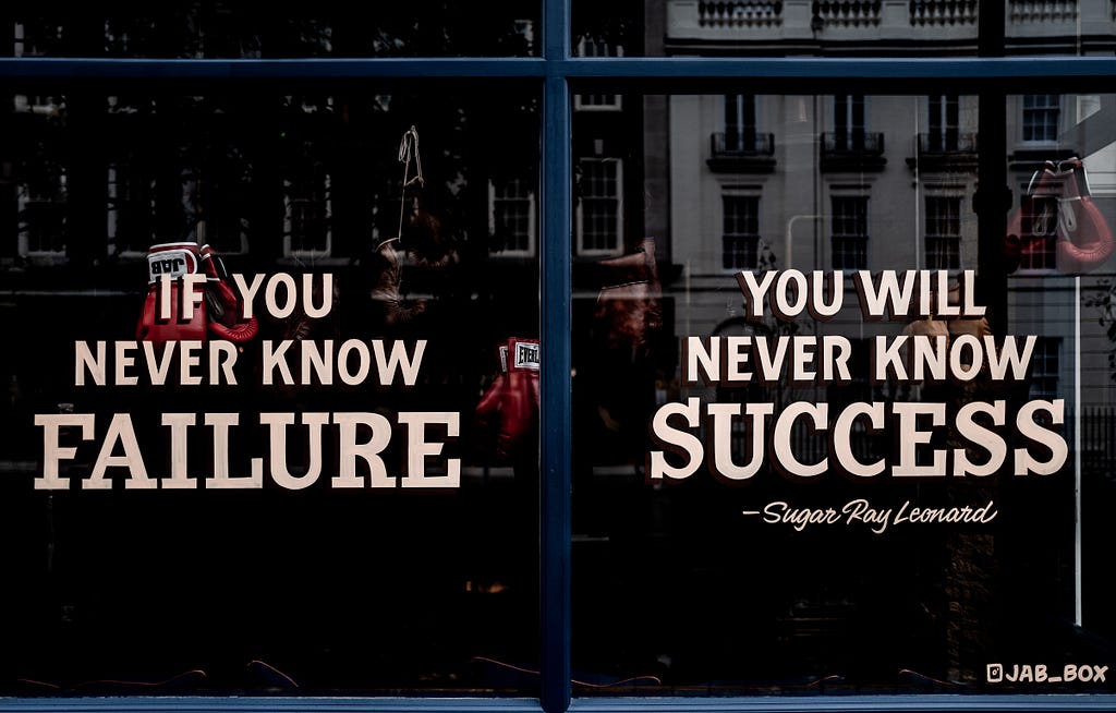 Window sign reading, “If you never know failure, you will never know success”