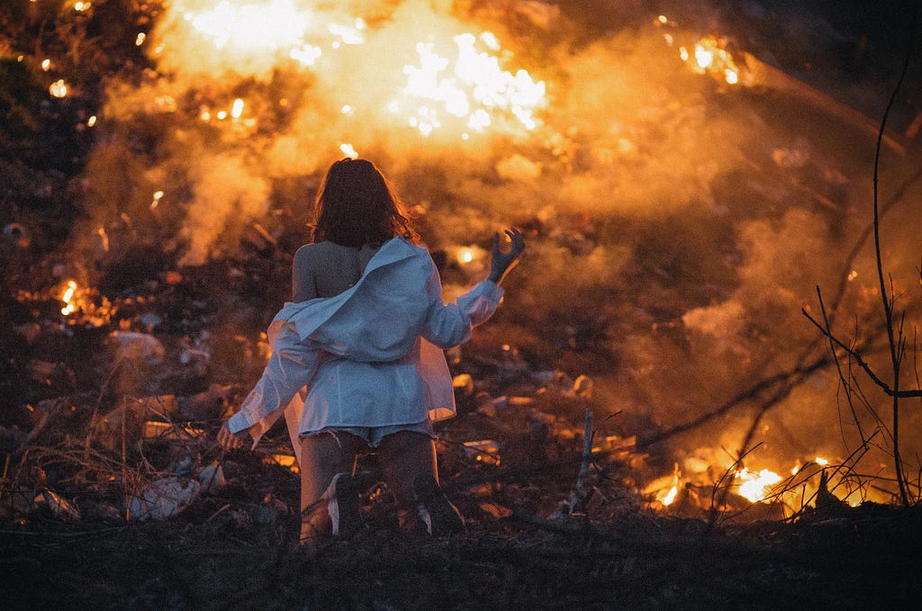 Woman watching a devastating fire.