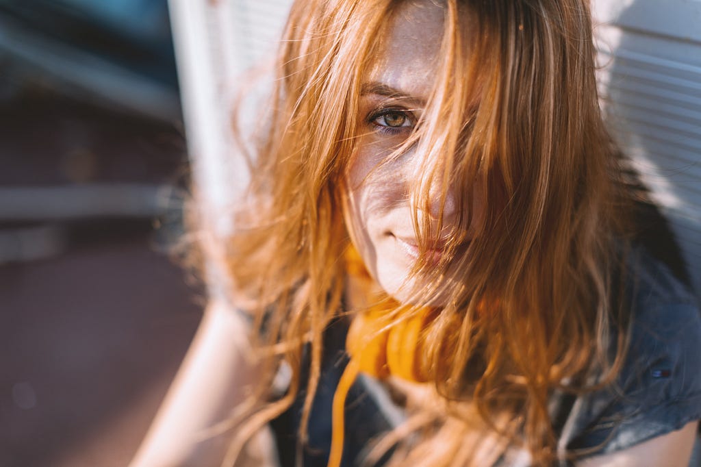 Picture of redhead woman, daydreamy and happy.